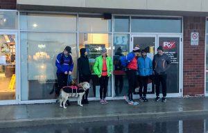 Runners under cover until they head out in the rain for their run. 
