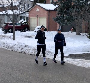 Two runners on the street. 