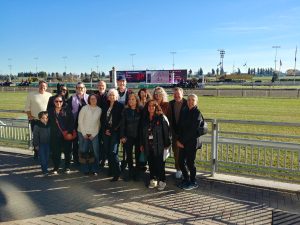 People standing in front of the rail at Woodbine race track.